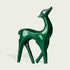 Vibrant Fiberglass Sculpture Christmas Reindeer Pair For Modern Decor. Two decorative deer statues, one red and one green on a light gray background