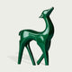 Vibrant Fiberglass Sculpture Christmas Reindeer Pair For Modern Decor. Two decorative deer statues, one red and one green on a light gray background