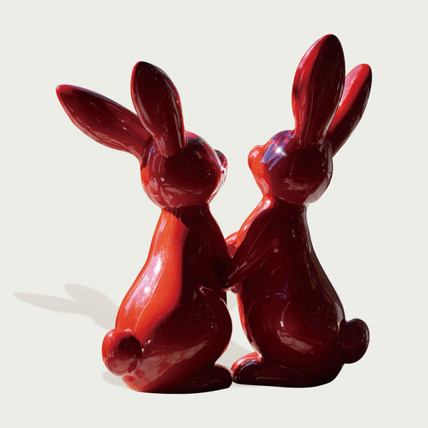 Dynamic Red Fiberglass Holding Hands Rabbit Pair on a white background