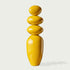 A Modern Glossy Yellow Stacked Pebble Fiberglass Sculpture on a white background