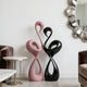 Elegant Pink and Black Flamingo Fiberglass Sculpture in a room with a mirror and furniture.