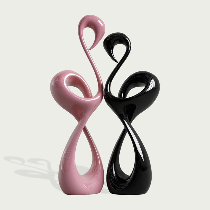 Elegant Pink and Black Flamingo Fiberglass Sculpture on a light gray background