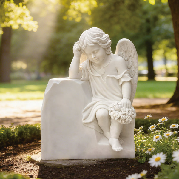 Classic cherub resting angel marble statue for cemetry memorials in a green garden with sunlights