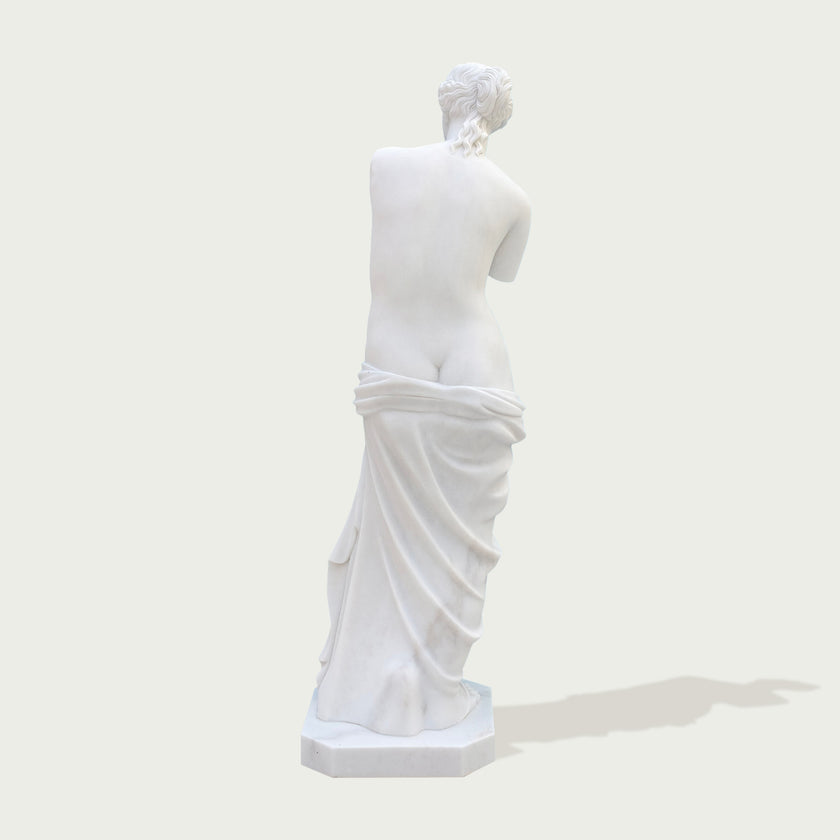 Venus de milo greek goddess sculpture replica on a light gray background