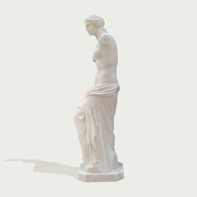 Venus de milo greek goddess sculpture replica on a light gray background