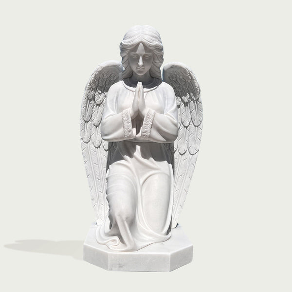 knneling praying angel marble statue on a white background