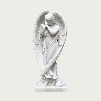 Elegant stainding praying marble angel statue on a light gray background