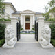 Classic Sitting Guardian Lion Marble Statue flanking a grand entrance with a mansion in the background