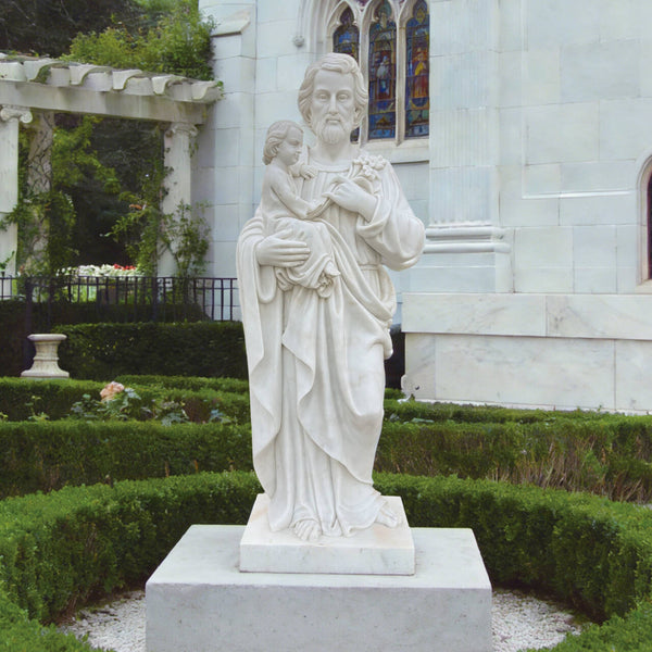 Sacred Saint Joseph And Child Marble Statue in front of a building with stained glass windows.
