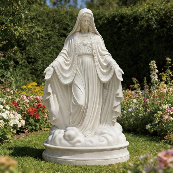 Mother Mary Our Lady Of Grace Marble Statue For Church Gardens in a garden with flowers and greenery