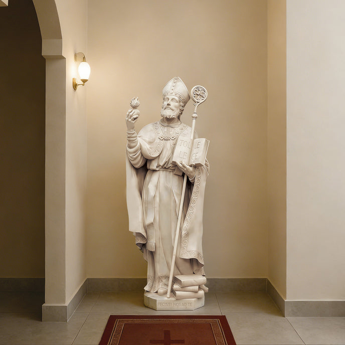 Catholic Saint Augustine Marble Sculpture holding a book and staff in a hallway with beige walls.