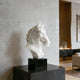 Modern Geometric Natural White Marble Horse Head Sculpture on a black pedestal against a gray wall.