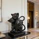 Modern Black Natural Marble Cats Statue  on a black marble base in an elegant interior setting.