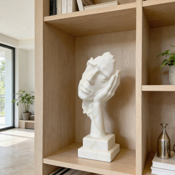 Fragmented Face Marble Sculpture on a wooden shelf in a modern room