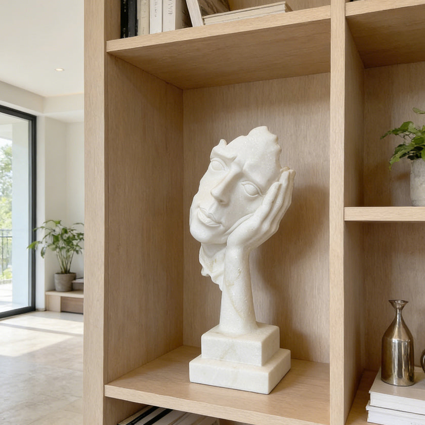 Fragmented Face Marble Sculpture on a wooden shelf in a modern room