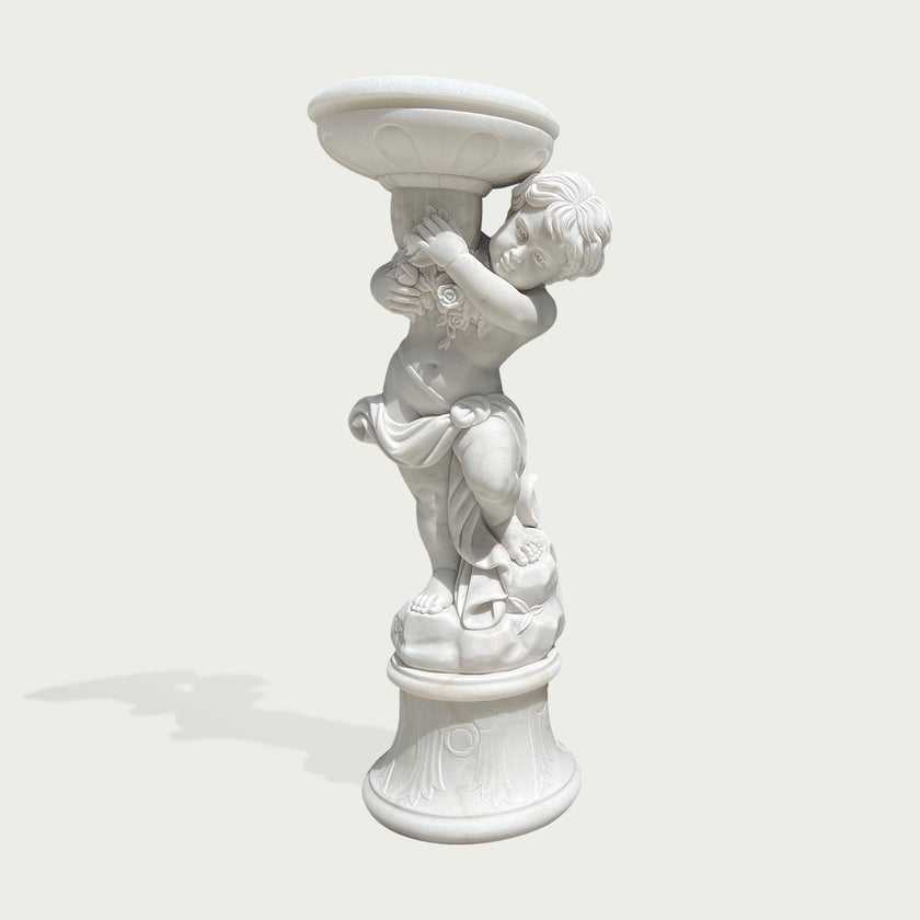 Natural white marble cherub planter statue with floral details, flowing drapery, and decorative bowl shown on a clean product background.