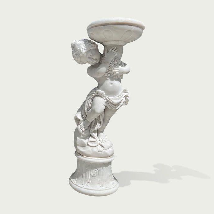 Natural white marble cherub flower planter statue with floral carving, flowing drapery, and decorative bowl on a clean background.