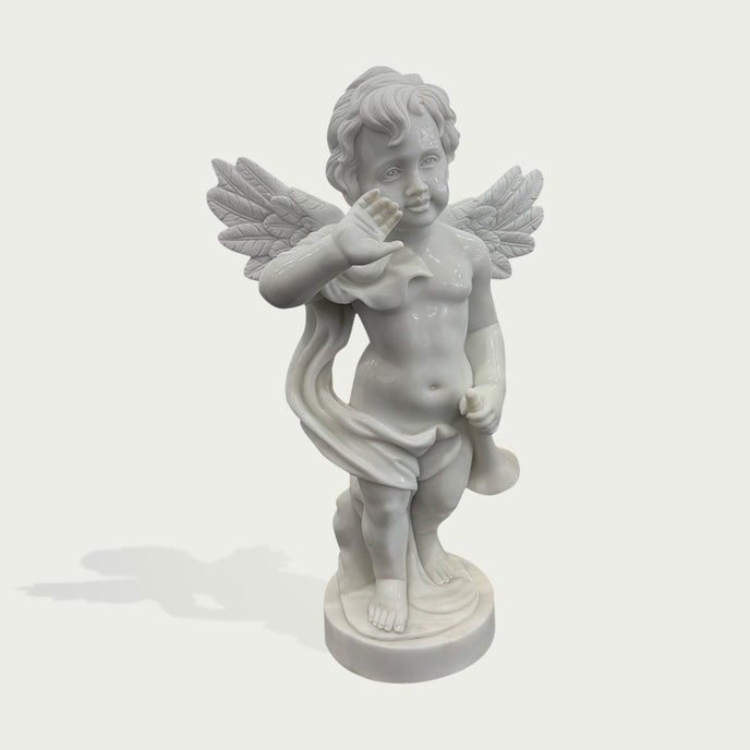 Natural white marble cherub angel statue with waving hand, feathered wings, flowing drapery, and small trumpet on a clean background.