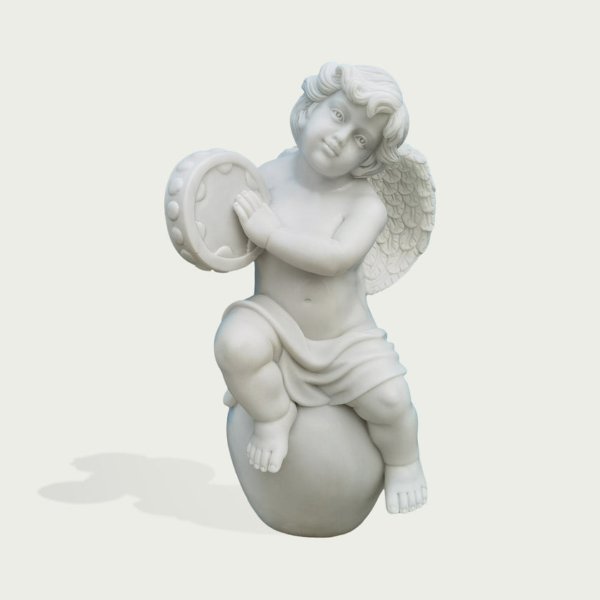 Natural white marble cherub tambourine statue with feathered wings, seated pose, soft drapery, and sweet carved facial details.