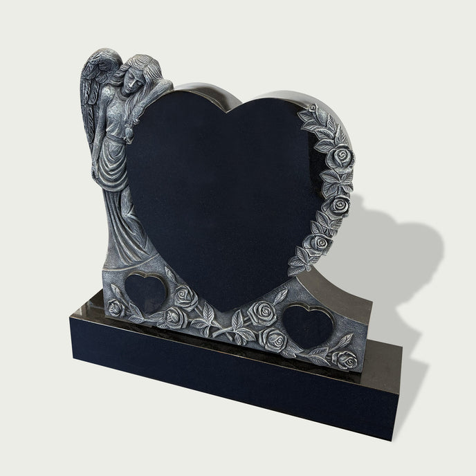 Guardian angel heart headstone with floral rose carvings, black granite heart panel, silver-toned angel figure, and elegant memorial base design.