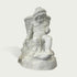 Natural white marble child statue seated with a woven basket, small cup, draped cloth, and fruit details on a clean background.