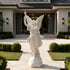 Natural white marble angel statue holding a raised torch and rose, displayed in a luxury villa courtyard with wings and flowing drapery.