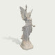 Side view of white marble angel statue with torch, rose, open wings, and wind-swept drapery carved in a classical style.