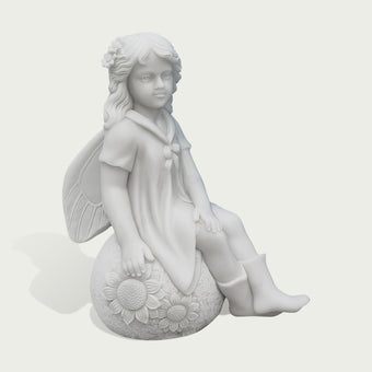 A white stone or resin figurine of a winged girl sitting on a sunflower-covered sphere, shown against a plain light gray background.