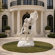 Natural white marble Apollo and Daphne sculpture showing intertwined figures, flowing drapery, and laurel branches during the dramatic transformation scene.