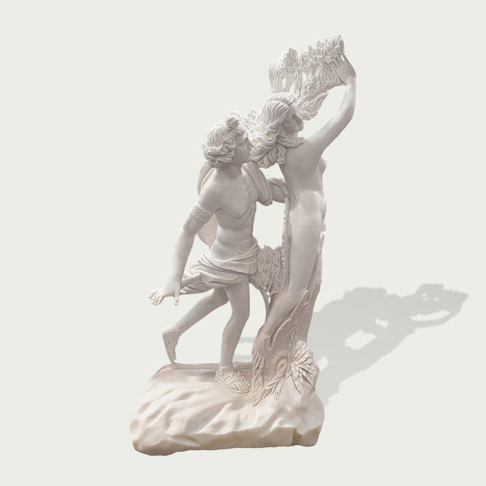 Apollo and Daphne marble statue displayed on a grand villa lawn, featuring dynamic movement, carved laurel leaves, and classical mythological detail.