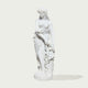 A white classical-style statue of a draped female figure standing on a round base, photographed against a plain light gray background with a soft shadow.
