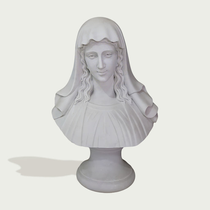 A white classical-style bust sculpture of a woman with long wavy hair and a draped veil, mounted on a round pedestal against a light gray background.