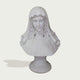 A white classical-style bust sculpture of a woman with long wavy hair and a draped veil, mounted on a round pedestal against a light gray background.