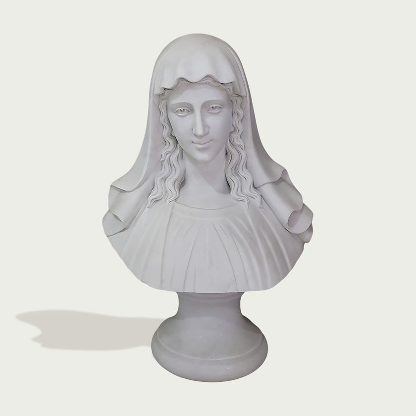 A white classical-style bust sculpture of a woman with long wavy hair and a draped veil, mounted on a round pedestal against a light gray background.