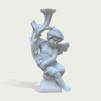 A white marble-style cherub statue seated on a pedestal, holding a large trumpet or horn-like vessel overhead, shown against a plain light beige background.