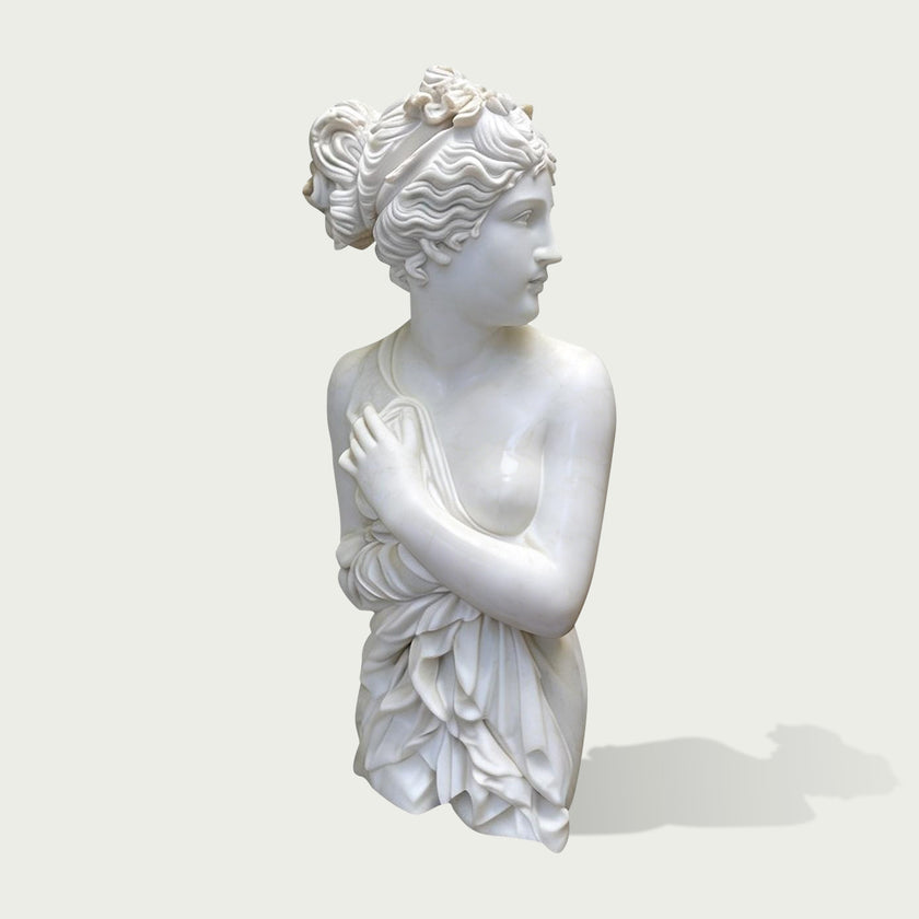 White marble female bust sculpture with floral updo hairstyle, classical Greek inspired statue with elegant carved details on a clean background