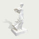 Side view of elegant white marble female sculpture with flowing fabric details and classical artistic design