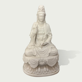 White marble Guanyin statue seated on lotus pedestal with intricate carved robes, peaceful expression, and traditional Buddhist sculpture details