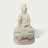 White marble Guanyin statue seated on lotus pedestal with intricate carved robes, peaceful expression, and traditional Buddhist sculpture details
