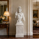White marble Roman warrior bust displayed in a luxury interior with classical decor and elegant pedestal setting.