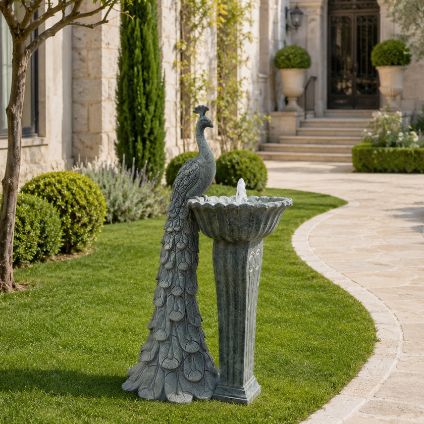 Outdoor peacock fountain garden sculpture displayed in landscape setting with classic stone design and elegant decorative appeal