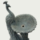 Close-up of antique grey marble peacock birdbath fountain with textured feathers and handcrafted outdoor sculpture details