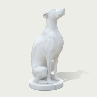 Side view of a white marble greyhound dog sculpture with sleek body shape, long neck, and minimalist artistic design.