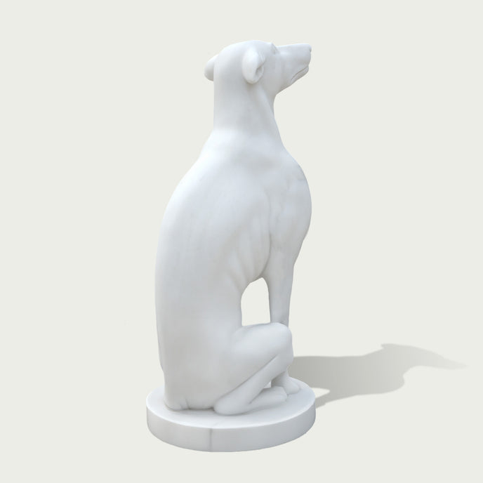 Back view of a white marble greyhound statue displaying smooth curves, detailed form, and handcrafted stone sculpture quality.