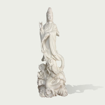 Front view of a white marble Guanyin Bodhisattva statue with serene expression, detailed garments, raised hand gesture and dragon ornament base for spiritual decor