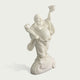 Side angle view of white stone Laughing Buddha sculpture showing detailed robe folds, balanced pose, expressive face and artistic carved pedestal design