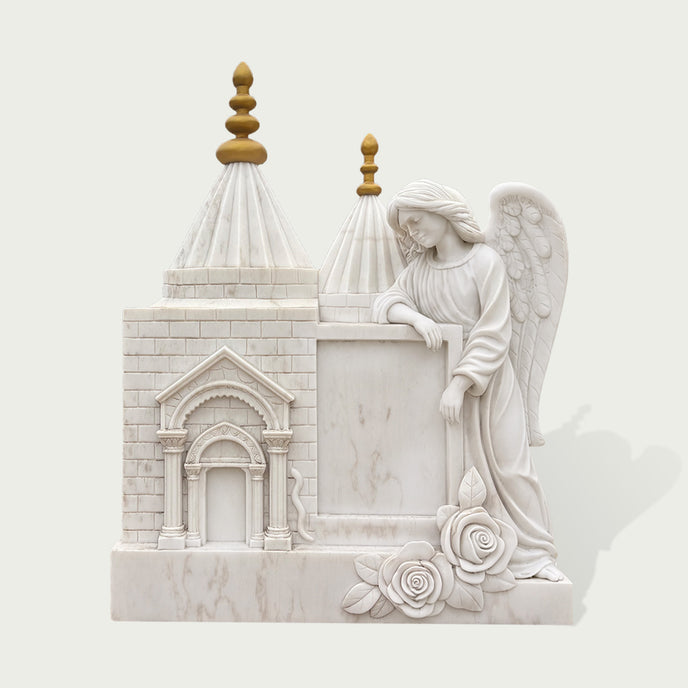 White marble angel memorial sculpture featuring a detailed church design, arched doorway, golden spires, roses, and carved wings for cemetery remembrance.