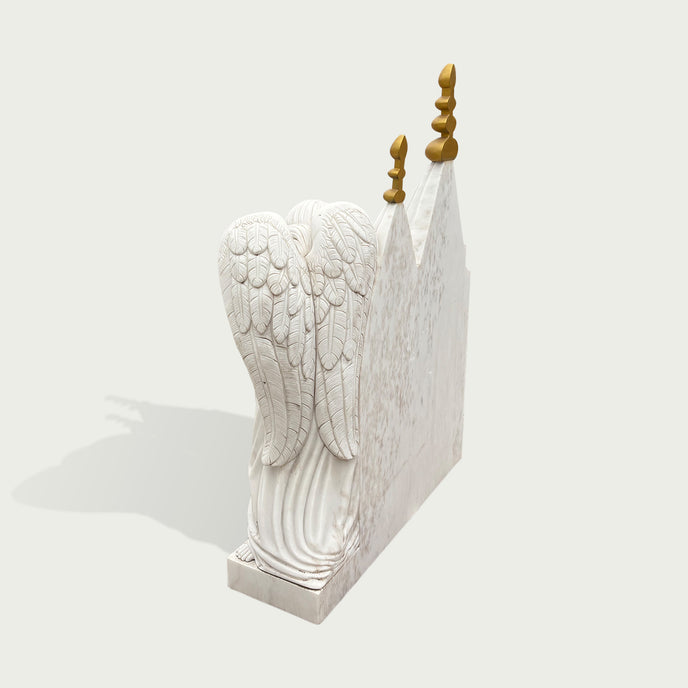 White marble chapel memorial headstone sculpture with angel figure, carved roses, architectural details, golden spires, and a peaceful remembrance design.