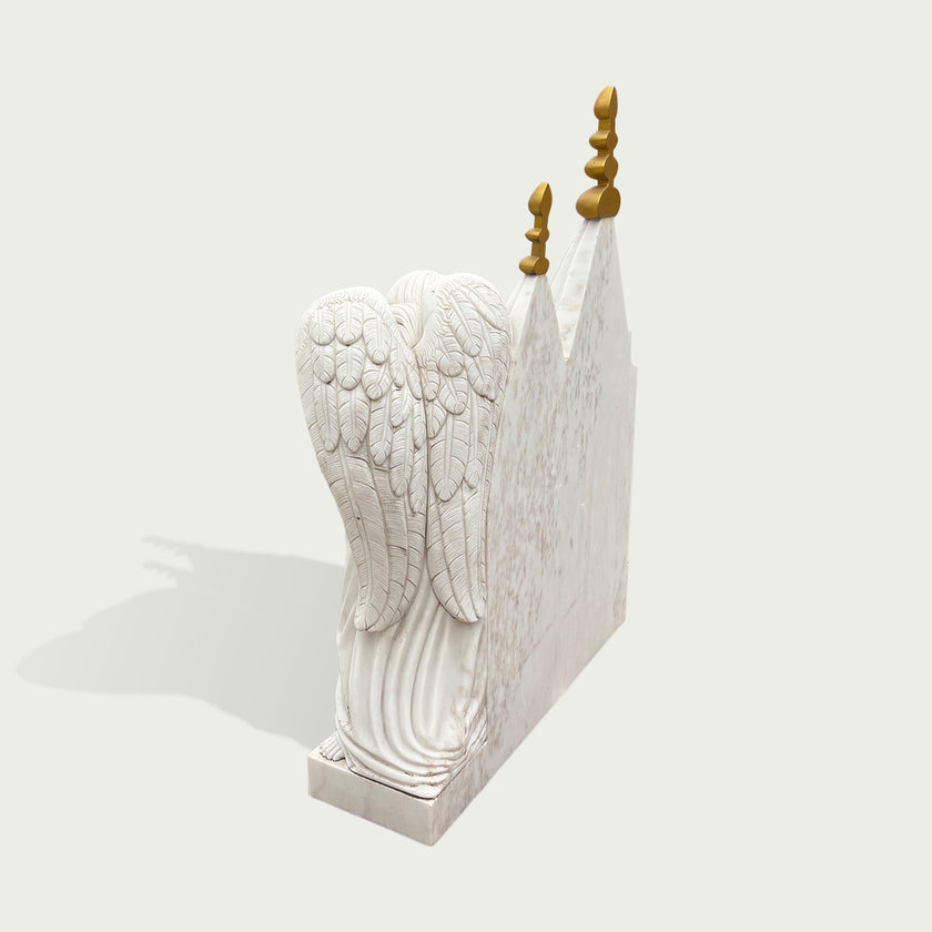White marble chapel memorial headstone sculpture with angel figure, carved roses, architectural details, golden spires, and a peaceful remembrance design.