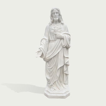 Classic white marble Jesus statue featuring Sacred Heart symbolism, flowing robes and a peaceful expression for outdoor church decoration.